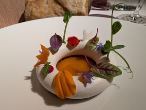 Course 8: Coconut cream ring topped with a variety of fruit drops and herbs at Joia Alta Cucina Naturale in Milan