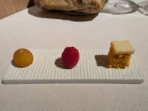 Petite dessert: pineapple marinated apple, hazelnut mousse filled raspberry, and carrot cake at Joia Alta Cucina Naturale in Milan