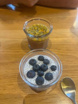 Blueberry chia pudding in the foreground and a tropical pudding in the background. at Harmonie Bowl & Juice in Strasbourg