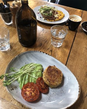 Sides of potato cake, tomato, and avocado. Toast with avo smash in background  at Black Betty Cafe in Christchurch