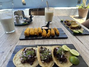Elotes, tacos de Jamaica, and tacos de falafel al pastor.   at Capuchino Cafe in La Paz