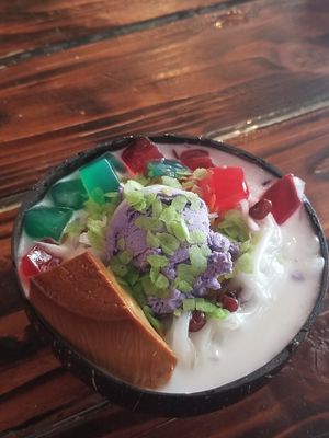 A little dessert after lunch. Served in a coconut bowl! at Nick's Kitchen in Daly City