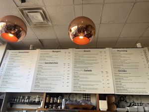 Large menu featuring smoothies, salads, bowls, wraps and burgers at Press Market in Collingwood