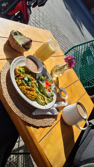 Tofu scrambled 'eggs' with bread, tropical juice and coffee with oat milk at Nomada Organics & Gourmet in La Paz