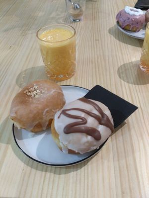 Apple pie doughnut, chocolate-filled doughnut and orange juice. at Delish Vegan Doughnuts in Madrid