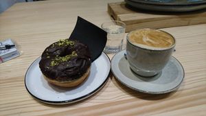 Chocolat, Pistaccio and salt donut with a cappuccino at Delish Vegan Doughnuts in Madrid