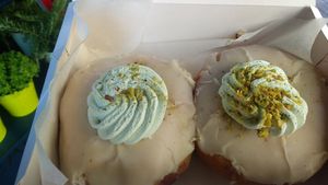Pomegranate filling with white chocolate and pistachio covering at Delish Vegan Doughnuts in Madrid