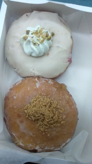 Pomegranate, white chocolate and pistachio mousse and apple pie doughnuts at Delish Vegan Doughnuts in Madrid