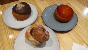 Peanut butter donut, cinnamon roll and matcha donut at Delish Vegan Doughnuts in Madrid