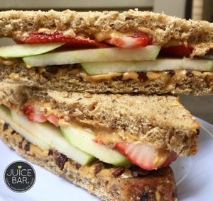 Almond Butter sandwich! Ingredients: almond butter, apples, strawberries, cacao nibs, local honey at I Love Juice Bar in Dallas