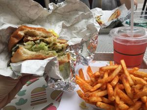 Crab cake burger fries and kombucha at PLANTA Burger in Toronto