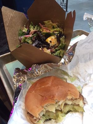 Artichoke crab cake burger and Caesar salad at PLANTA Burger in Toronto