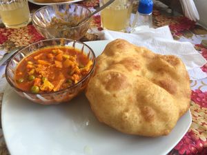 Puffy bread and perfectly spiced curry! at Krishna Bhog in Huaraz