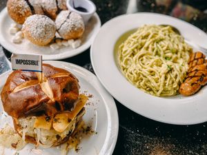 Truffle burger, ube beignets, linguini pasta with Beyond bratwurst  at CyBelle's Front Room in San Francisco