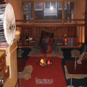 Persian-style floor seating on the first floor, where mantras singing takes place every Friday after closing (the tables fold to the wall). at Golden Temple in Amsterdam