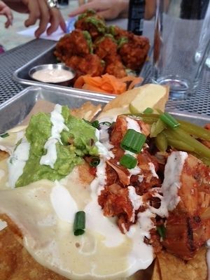 Nachos with added jackfruit and cauliflower wings in the background. at BoltCutter in Salt Lake City