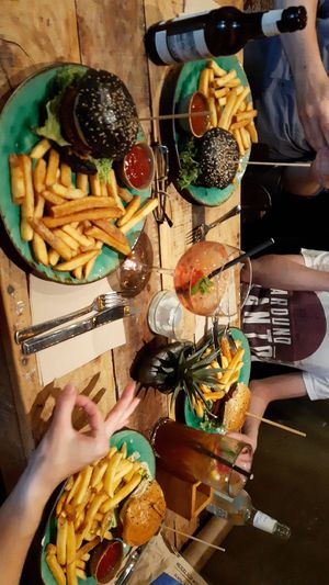 Burger with fries, wildberry lillet and homemade lemonade at Bidges & Sons Reeperbahn in Hamburg