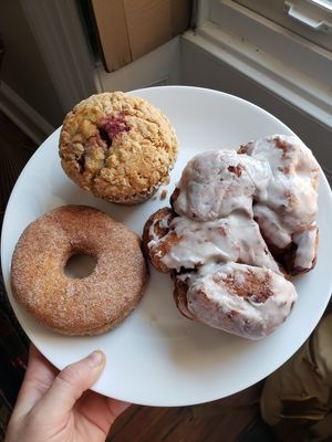 Huge apple fritter, cinnamon sugar donut, and strawberry cardamom muffin. Photo taken June 2019. at Dottie's Donuts - Queen Village in Philadelphia