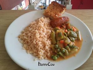 Mock sausage made of peas, zucchini salad, brown rice, and pineapple cake. at Loto Azul Vegetariano in Bogota