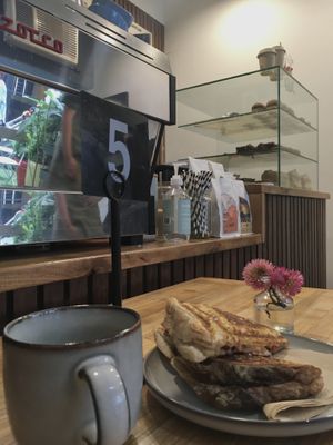 Vegan bean and cheese jaffle with a cup of coffee  at Union Kiosk in Melbourne