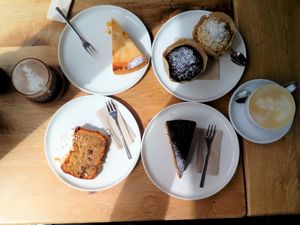 mango-cheesecake, muffins, banana bread, apricot-choco-poppyseed-cake, raw hot chocolate, Milchkaffee at Sturbock Cafe in Wurzburg