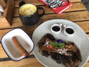 Vegan pancakes, sausage and turmeric latte with coconut milk  at The Factory Cafe in Koh Tao