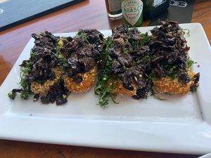 Polenta crostinis with mushrooms and crispy kale  at Mergulhao in Fernando De Noronha