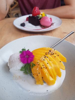 Dessert, fresh mango, warm coconut sauce with ginger icecream at Nama in Mallorca