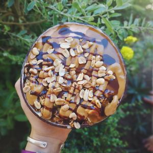 Snickers bowl. Two-toned with a thick velvetly chocolate layer and a peanutbutter and banana layer. Topped with nutty homemade granola, banana,  PB, salted caramel sauce and chocolate sauce.   at Bom Bowls in Pai