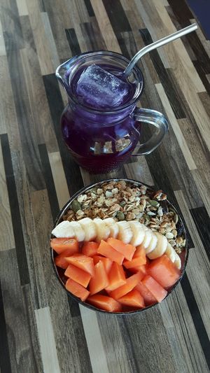 Acai bowl with extra fruit and butterfly pea cold tea  at Bom Bowls in Pai