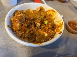 I believe this to be the "butter" curry that appeared on the table without explanation. Was good. at Foo Dog Curry Traders in Jacksonville