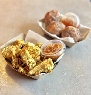 Crispy Jackfruit Nuggets with curry ketchup and Rice A Rollies with sweet chili sauce. at Foo Dog Curry Traders in Jacksonville