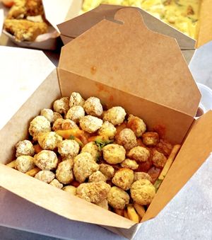 Butter Chicken over Fries with vegan popcorn chicken. at Foo Dog Curry Traders in Jacksonville