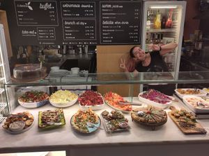 The savory spread, with serving person in the background :) at DaTerra - Mercado Beira Rio in Vila Nova De Gaia