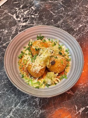 Homemade saffran and mozarella arancini on tomato sauce and fennel  at Dirty Records Bar in Gothenburg