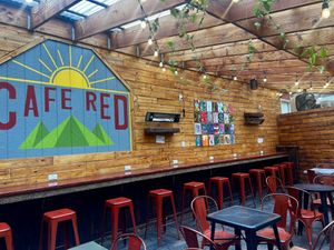 Covered outdoor seating with heat lamps on the ceiling  at Cafe Red in Seattle