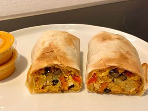 bacon breakfast burrito (plated at home) at Cafe Red in Seattle