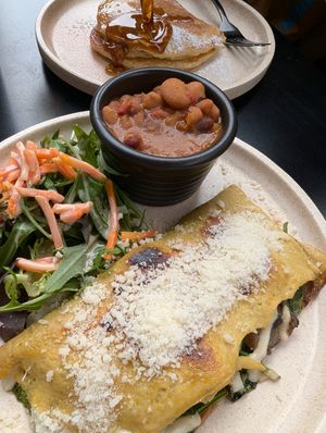 vegan omelette with a side of beans, pancakes in the background at Shift Eatery in Surry Hills