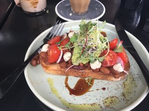 Smoky baked beans with a avocado smash, tomatoes and cashew cheese at Shift Eatery in Surry Hills