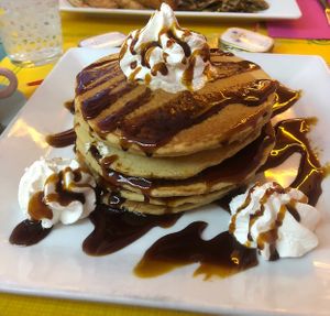 Pancakes with caramel syrup and whipped cream  at Freedom Cakes Bakery in Madrid