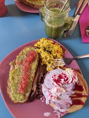 Combo platter with pancakes, tofu scramble, "bacon", and toast with avocado and tomato at Freedom Cakes Bakery in Madrid