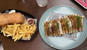 Calamari sandwich and fries on the left, Club sandwich on the right   at Freedom Cakes Bakery in Madrid