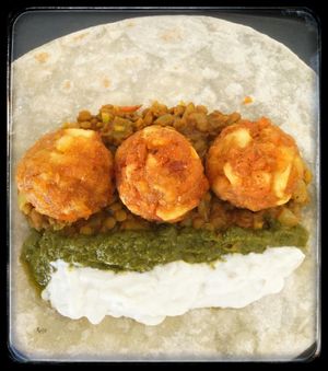 Indian burrito comes with curried lentils, 3 crispy Indian balls, cilantro chutney and cucumber cream. It can be made vegan upon request. at Papa Tots in Puerto Escondido