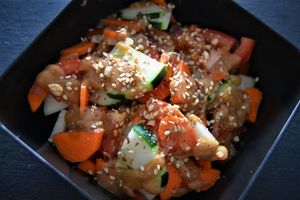 Asian salad comes with cucumber, carrot, tomato and a Thai peanut dressing with toasted sesame seeds and crushed peanuts. at Papa Tots in Puerto Escondido