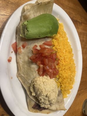 Vegan burrito with refried beans and onions served with rice, avocado, tomatoes and hummus  at Cafe Mosaico in Quito
