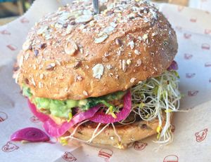Guadalupe Burger: black bean and roasted corn patty with guacamole, pickled red onions, tomatoes, alfalfa on a sprout bun. at Bareburger in Chicago