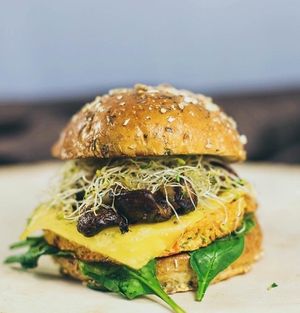 Prairie Burger: farmer's quinoa patty, vegan American, balsamic roasted mushrooms and garlic caramelizad onions, baby spinach, alfalfa on sprout bun at Bareburger in Chicago
