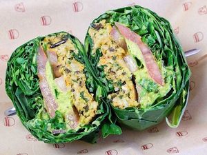 Farmstead Burger: sweet potato & wild rice patty, green hummus, tomatoes, baby kale, avocado basil dressing, collard green wrap at Bareburger in Chicago