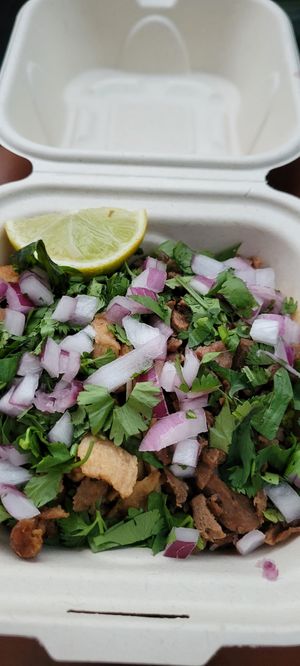 Tacos!  You can't even see the tortillas. Two tacos can easily be turned into for. at El Cocinero Restaurant in Van Nuys