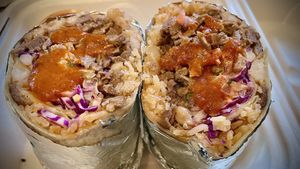 Asada burrito extra chipotle mayo cut in half .   at El Cocinero Restaurant in Van Nuys